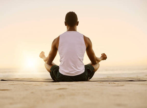 Adult person in a calm yoga pose in a bright, peaceful space